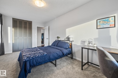 Bedroom featuring carpet flooring, a closet, and a textured ceiling - 1502 9909 110 Street, Edmonton, AB - Indoor Photo Showing Bedroom