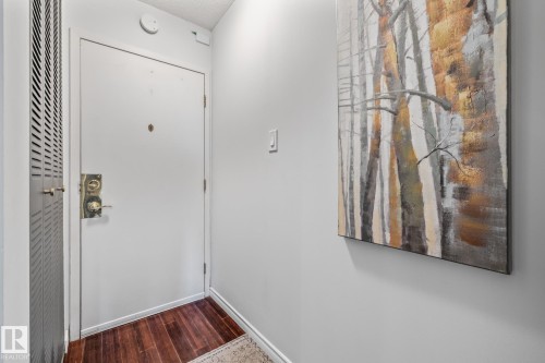 Doorway to outside with wood finished floors and baseboards - 1502 9909 110 Street, Edmonton, AB - Indoor Photo Showing Other Room