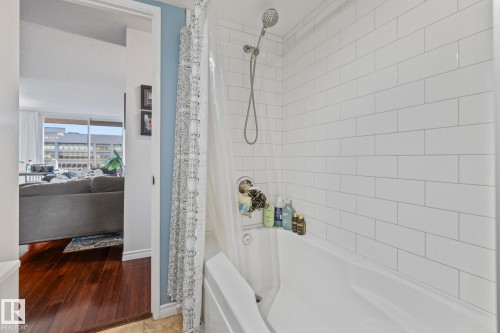 Ensuite bathroom featuring shower / bath combo and baseboards - 1502 9909 110 Street, Edmonton, AB - Indoor Photo Showing Bathroom