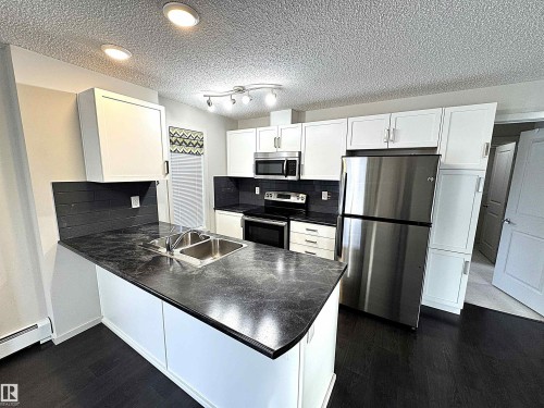 117 5521 7 Avenue, Edmonton, AB - Indoor Photo Showing Kitchen With Stainless Steel Kitchen With Double Sink