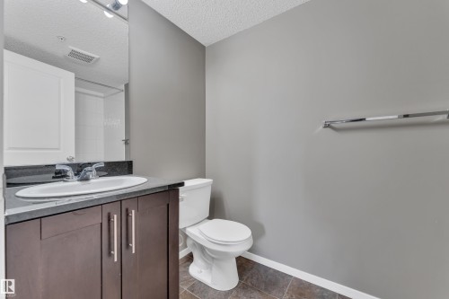 Half bathroom with vanity and a textured ceiling - 216 5804 Mullen Place, Edmonton, AB - Indoor Photo Showing Bathroom