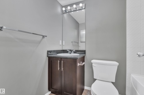 Full bath with vanity and bathing tub / shower combination - 216 5804 Mullen Place, Edmonton, AB - Indoor Photo Showing Bathroom