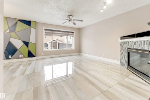 3232 27 Avenue, Edmonton, AB - Indoor Photo Showing Other Room With Fireplace