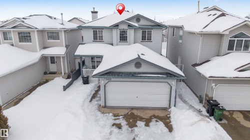 View of front of house featuring a garage and a residential view - 3232 27 Avenue, Edmonton, AB - Outdoor With Facade