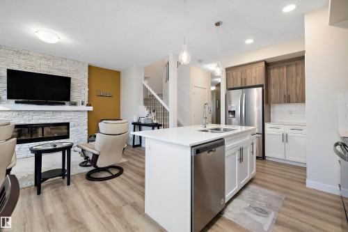73 Garneau Gate, Spruce Grove, AB - Indoor Photo Showing Kitchen With Fireplace With Double Sink With Upgraded Kitchen