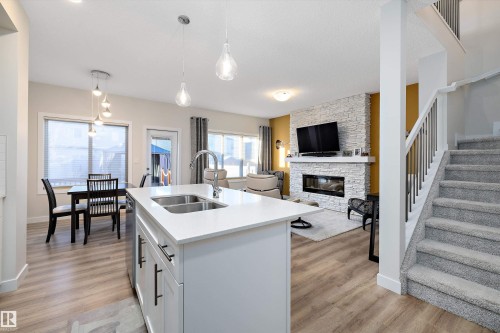 73 Garneau Gate, Spruce Grove, AB - Indoor Photo Showing Kitchen With Fireplace With Double Sink