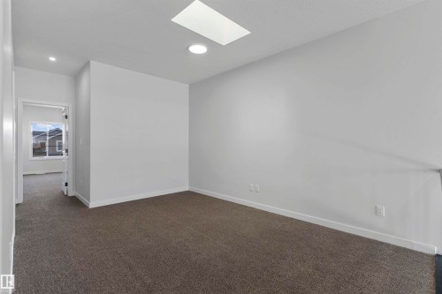 Spare room featuring dark colored carpet, a skylight, and recessed lighting - 116 25 Street, Edmonton, AB - Indoor Photo Showing Other Room
