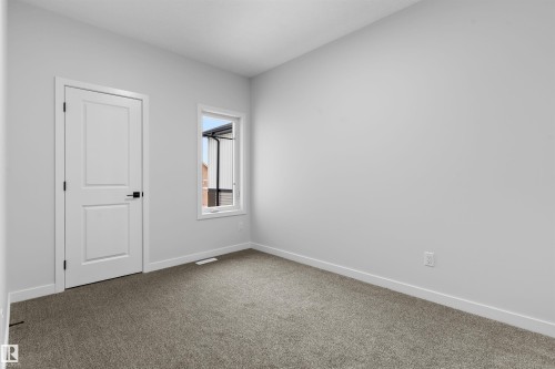 Empty room with baseboards and dark colored carpet - 116 25 Street, Edmonton, AB - Indoor Photo Showing Other Room