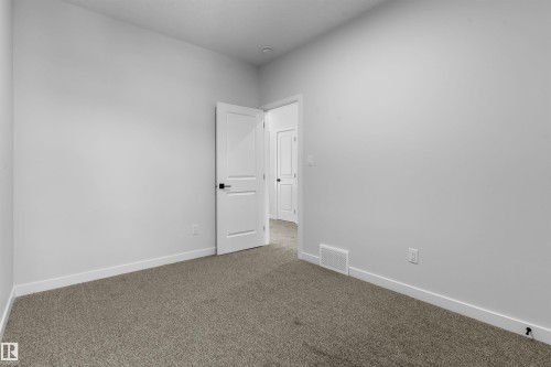 Spare room with dark colored carpet and baseboards - 116 25 Street, Edmonton, AB - Indoor Photo Showing Other Room