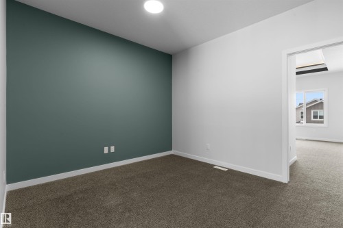 Spare room featuring baseboards and dark carpet - 116 25 Street, Edmonton, AB - Indoor Photo Showing Other Room