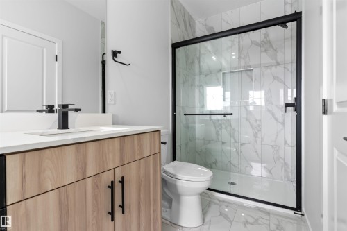 Full bathroom with vanity, light marble finish floors, and a marble finish shower - 116 25 Street, Edmonton, AB - Indoor Photo Showing Bathroom