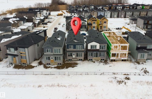 Snowy aerial view with a residential view - 116 25 Street, Edmonton, AB - Outdoor With Facade