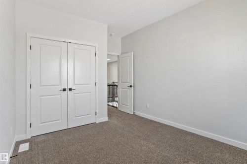 Unfurnished bedroom featuring carpet flooring and a closet - 116 25 Street, Edmonton, AB - Indoor Photo Showing Other Room