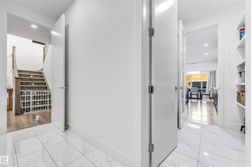Corridor with recessed lighting and light marble finish floors - 1407 Graydon Hill Way, Edmonton, AB - Indoor Photo Showing Other Room