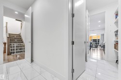 Corridor with recessed lighting and light marble finish floors - 