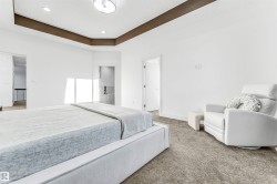Bedroom with carpet, a raised ceiling, and recessed lighting - 