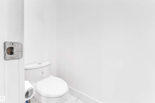 Bathroom with baseboards and marble look tiles - 1407 Graydon Hill Way, Edmonton, AB - Indoor Photo Showing Bathroom