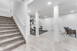 Stairway featuring wood finished floors and recessed lighting - 