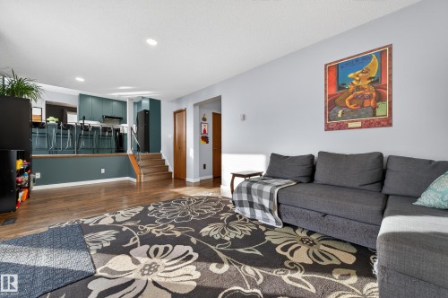 Living room featuring dark wood-style flooring and recessed lighting - 9215 Ottewell Road, Edmonton, AB - Indoor Photo Showing Living Room