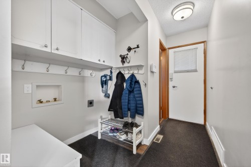 Mudroom featuring a textured ceiling and carpet floors - 9215 Ottewell Road, Edmonton, AB - Indoor Photo Showing Other Room