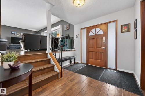 Foyer with dark wood finished floors and a textured ceiling - 9215 Ottewell Road, Edmonton, AB - Indoor Photo Showing Other Room