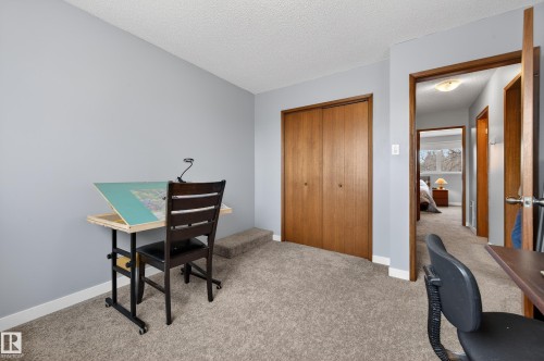 Office area featuring carpet floors and a textured ceiling - 9215 Ottewell Road, Edmonton, AB - Indoor