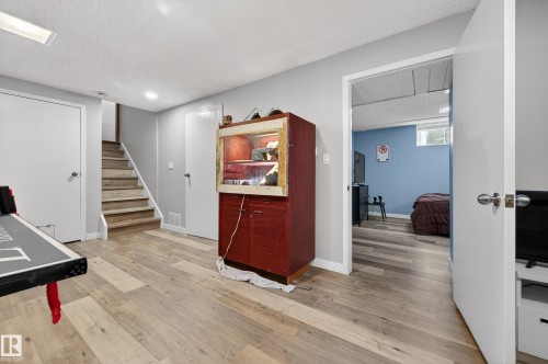 Home office featuring a textured ceiling and light wood-style flooring - 9215 Ottewell Road, Edmonton, AB - Indoor