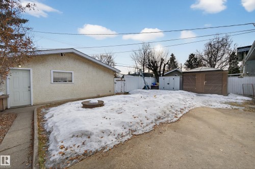 Yard covered in snow featuring a fenced backyard and a shed - 9215 Ottewell Road, Edmonton, AB - Outdoor