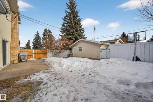 Yard layered in snow featuring a fenced backyard, a gate, and a patio - 9215 Ottewell Road, Edmonton, AB - Outdoor