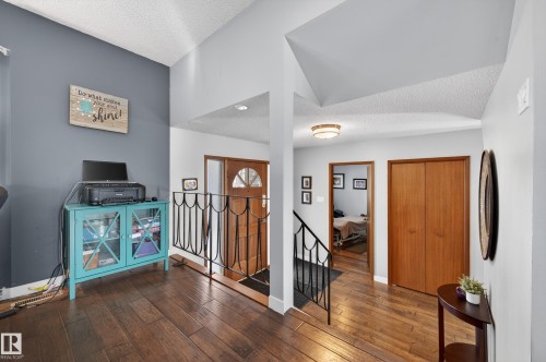 Entryway featuring a textured ceiling and hardwood / wood-style floors - 9215 Ottewell Road, Edmonton, AB - Indoor Photo Showing Other Room
