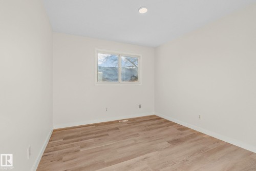 Empty room with light wood-type flooring and baseboards - 4631 126 Avenue, Edmonton, AB - Indoor Photo Showing Other Room