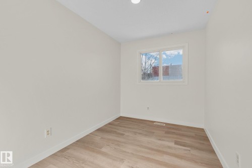 Spare room with light wood-style flooring and baseboards - 4631 126 Avenue, Edmonton, AB - Indoor Photo Showing Other Room