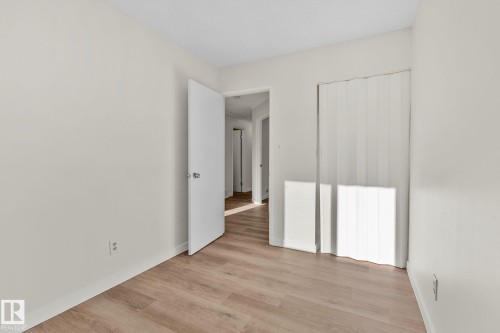 Unfurnished bedroom with light wood-style floors and baseboards - 4631 126 Avenue, Edmonton, AB - Indoor Photo Showing Other Room