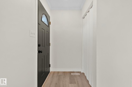 Entryway featuring light wood finished floors and crown molding - 4631 126 Avenue, Edmonton, AB - Indoor Photo Showing Other Room