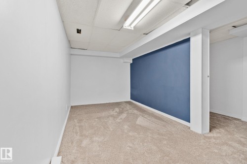 Finished below grade area with a paneled ceiling and light colored carpet - 4631 126 Avenue, Edmonton, AB - Indoor Photo Showing Other Room