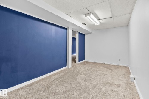 Carpeted spare room featuring a paneled ceiling and baseboards - 4631 126 Avenue, Edmonton, AB - Indoor Photo Showing Other Room