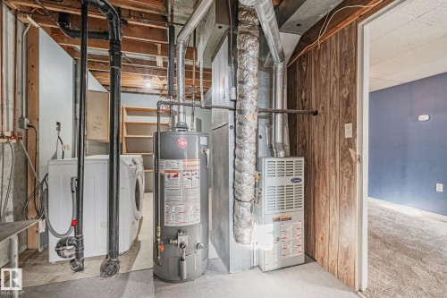 Utility room featuring gas water heater and heating unit - 4631 126 Avenue, Edmonton, AB - Indoor Photo Showing Basement