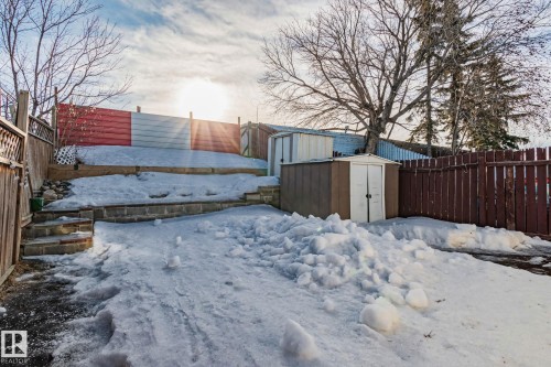 Yard covered in snow with a storage shed and a fenced backyard - 4631 126 Avenue, Edmonton, AB - Outdoor