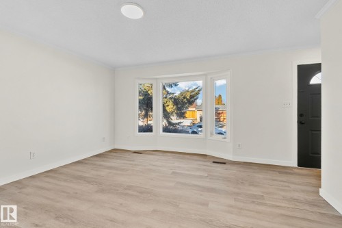Spare room with light wood-type flooring and crown molding - 4631 126 Avenue, Edmonton, AB - Indoor