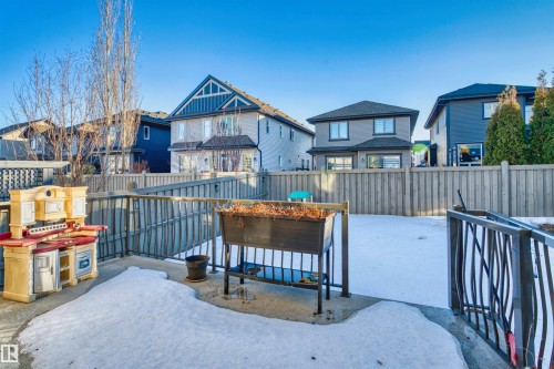 View of front of property with a fenced backyard, a residential view, and a patio area - 2036 Ainslie Link Link, Edmonton, AB - Outdoor