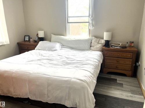 Bedroom featuring dark wood finished floors - 4811 48 Ave, Evansburg, AB - Indoor Photo Showing Bedroom