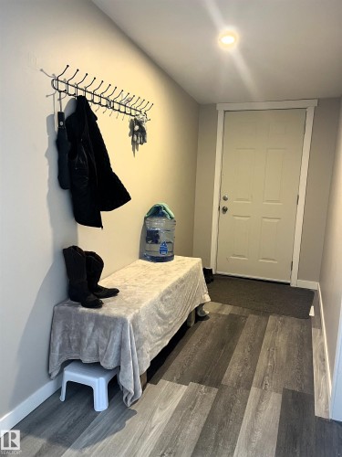 Mudroom with baseboards and dark wood-type flooring - 4811 48 Ave, Evansburg, AB - Indoor Photo Showing Bedroom