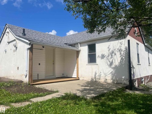 Back of property featuring roof with shingles, stucco siding, and a patio - 4811 48 Ave, Evansburg, AB - Outdoor With Exterior