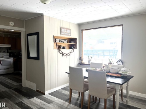 Dining area featuring crown molding and dark wood-style floors - 4811 48 Ave, Evansburg, AB - Indoor Photo Showing Dining Room