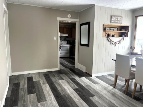 Corridor with crown molding, light wood finished floors, and wooden walls - 4811 48 Ave, Evansburg, AB - Indoor Photo Showing Other Room