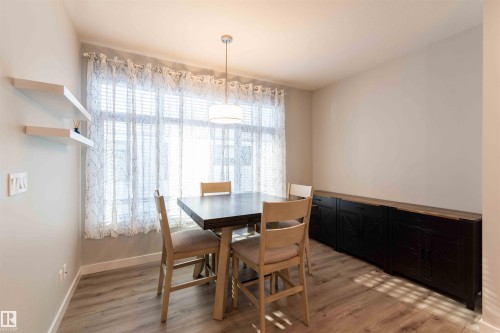 Dining area featuring healthy amount of natural light and light wood-type flooring - 21 1729 Keene Crescent, Edmonton, AB - Indoor Photo Showing Dining Room