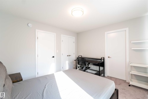 Bedroom with light carpet and a closet - 21 1729 Keene Crescent, Edmonton, AB - Indoor Photo Showing Bedroom