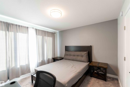 Bedroom with light carpet and baseboards - 21 1729 Keene Crescent, Edmonton, AB - Indoor Photo Showing Bedroom