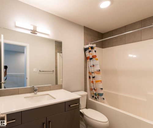 Bathroom featuring shower / bath combination with curtain, vanity, and recessed lighting - 21 1729 Keene Crescent, Edmonton, AB - Indoor Photo Showing Bathroom