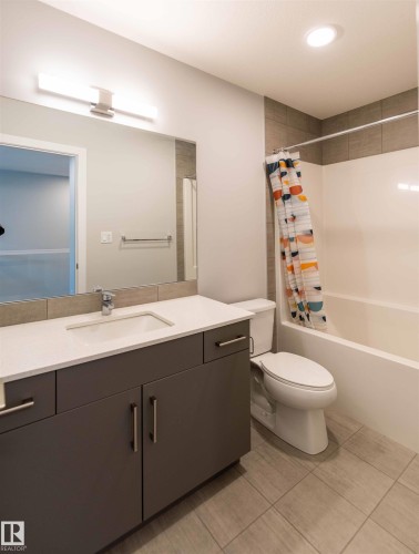 Full bath with shower / bath combo, vanity, light tile patterned floors, and recessed lighting - 21 1729 Keene Crescent, Edmonton, AB - Indoor Photo Showing Bathroom